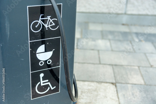 Pictograms on the sidewalk depicting a bicycle, a stroller, and a wheelchair