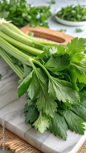 Fresh Celery Stalks on White Marble Cutting Board