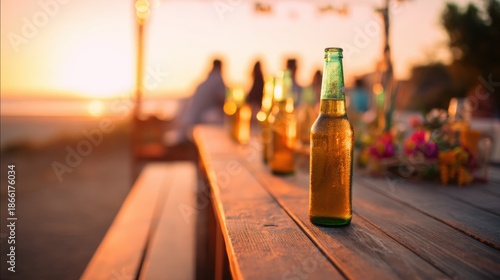People gather on the beach at sunset with drinks on the table