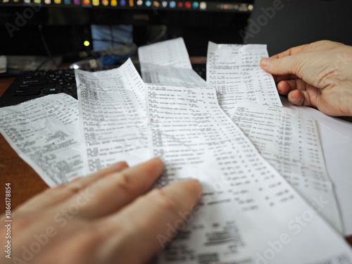 Multiple shopping receipts spread on desk, financial paperwork and expense tracking concept, consumer spending and budget planning background