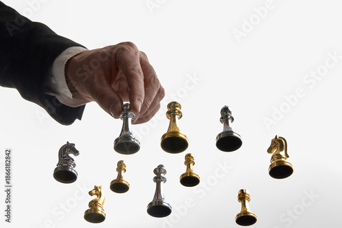 Fotografia Businessman choosing silver chess piece on white backdrop