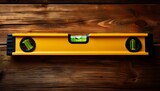 bright yellow spirit level on weathered wood surface close up