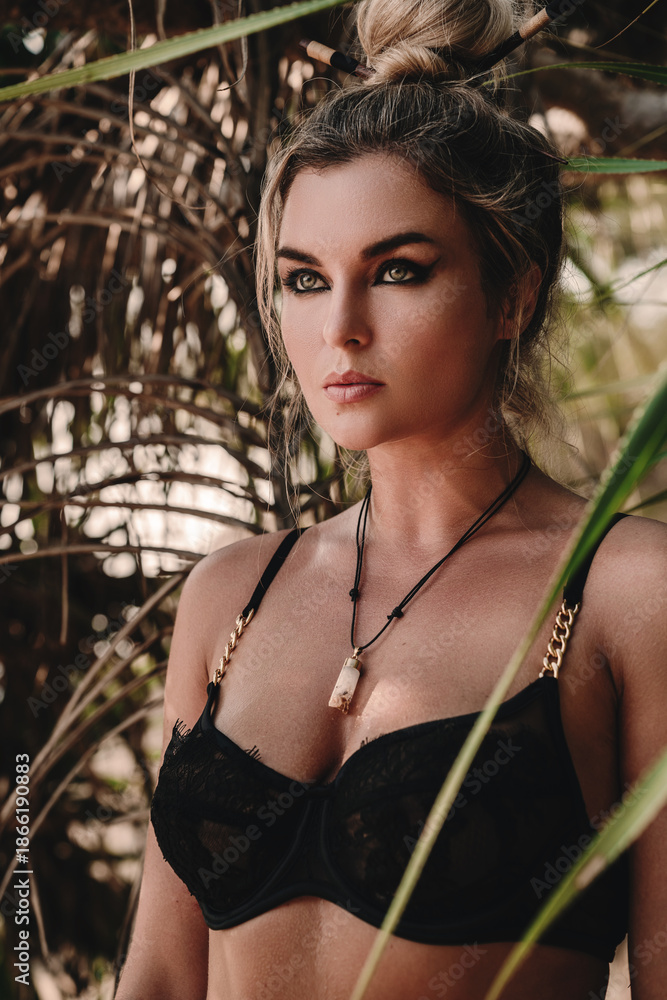 © blackday - Close-up portrait of confident woman wearing black lace lingerie among tropical palm leaves © blackday - Close-up portrait of confident woman wearing black lace lingerie among tropical palm leaves