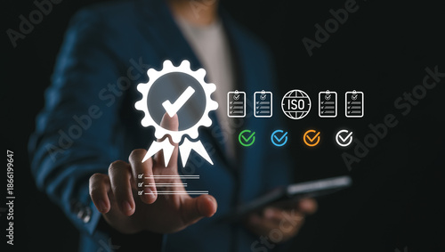 Tablou pe pânză Businessman selecting a quality assurance certification icon on a virtual screen, symbolizing ISO standards, compliance, quality control, and business process improvement in corporate governance