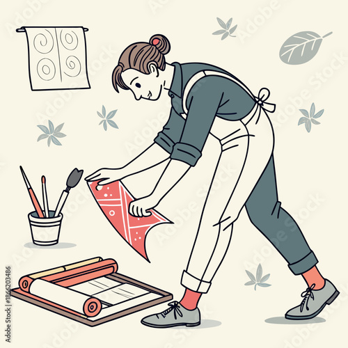 Woman creating artwork in studio with brushes and painting papers