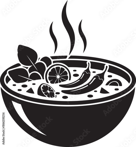 Black and white bowl of soup with chili peppers and lime
