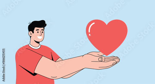 Smiling young man in a red shirt holding his hands out to present a large, shiny red heart, symbolizing love and kindness.