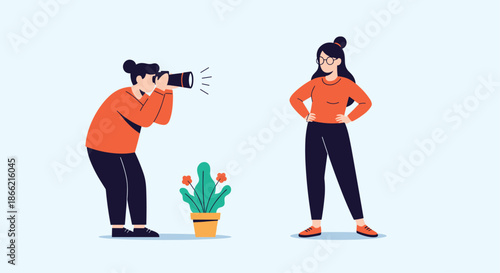 A professional photographer taking a picture of a confident female model posing for a photoshoot in a studio setting with a plant.