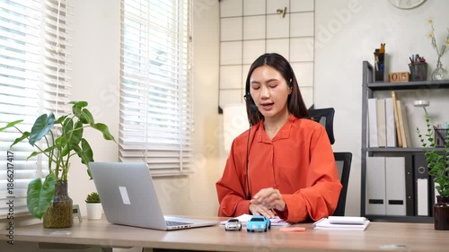 A young Asian businesswoman is holding a miniature car model, symbolizing auto insurance planning, vehicle financing, or automotive consulting in a modern office setting.
