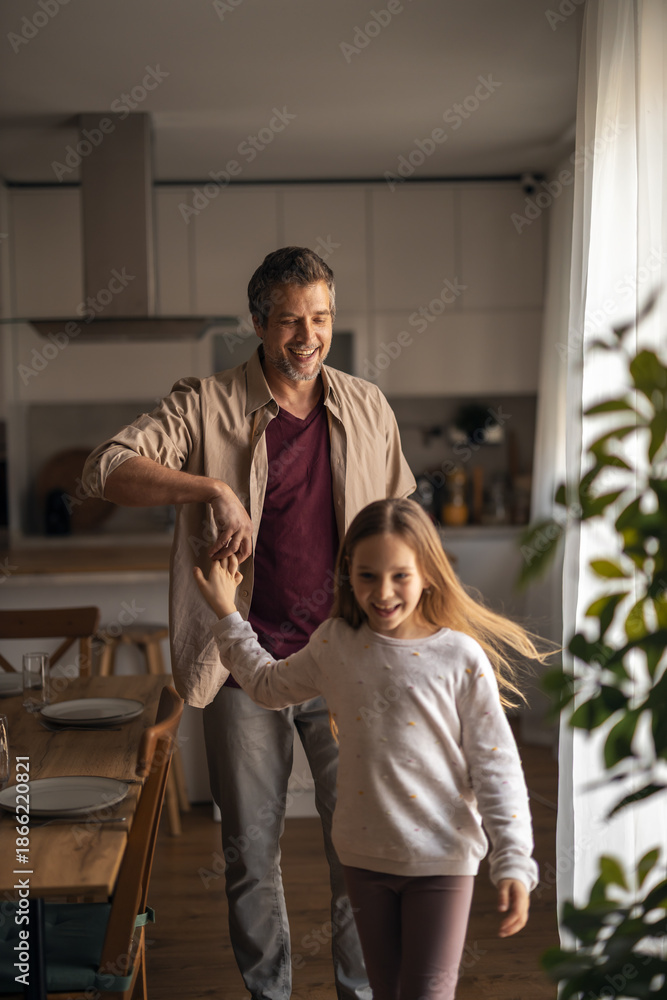 Fototapeta premium Father and daughter dancing together at home