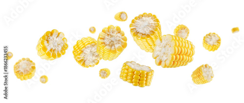 Peeled and sliced corn cobs fly and levitate in space. Isolated on white.