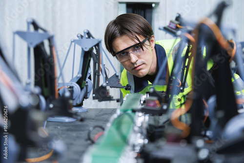 automation machine engineer students study and inspection control robot arm machine in robotics engineering academy at university or factory workshop. AI robot technology, future innovation trend.