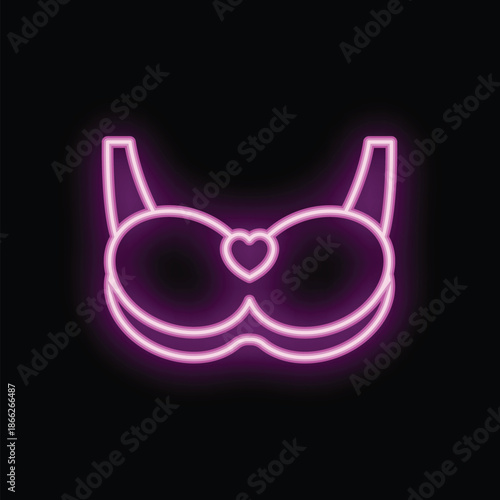 Neon pink bra with a heart in the middle is shining on a black background