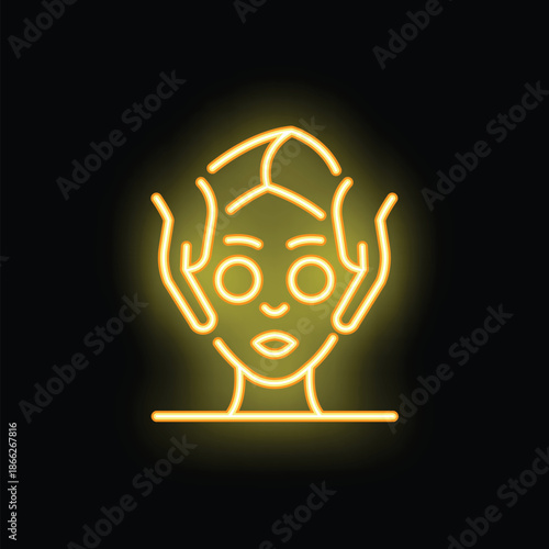 Yellow neon sign representing a facial massage for skincare and wellness, on a black background
