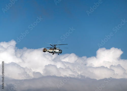 August 21, 2025: Novorossiysk, Russia: Ka-27 military helicopter flying in the sky against clouds, illustrating naval aviation, air patrol and defense activity on the Black Sea coast