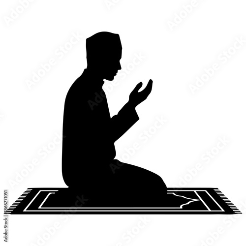 Silhouette of a Muslim man praying on a prayer mat.