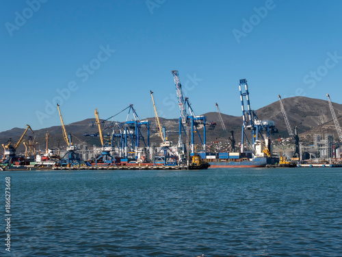 Photos August 22 2025 View of Novorossiysk port Russia with cargo ships and cranes on the coastline