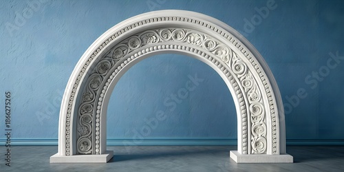 Intricate white plaster archway with ornate floral carvings and classical patterns standing against textured blue wall interior