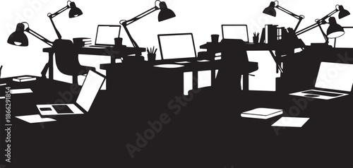 Silhouette of a busy office workspace with computers and lamps