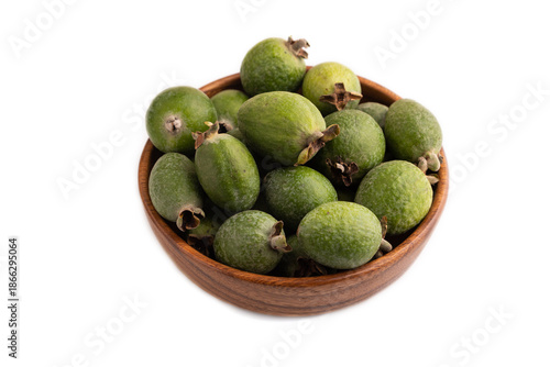 Ripe Feijoa in wooden bowl isolated on white, side view, close up