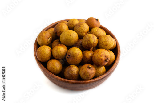 Ripe Longan in wooden bowl isolated on white, side view, close up