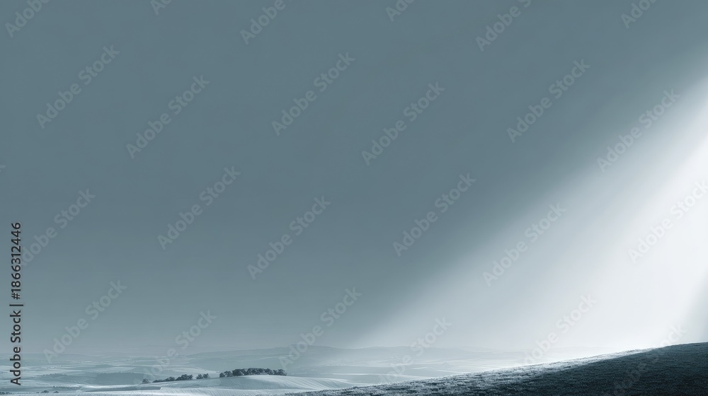 Fototapeta premium Serene Landscape with Soft Light Rays Illuminating Rolling Hills and Gentle Fields Under a Calm Sky in Monochrome Tones and Minimalist Aesthetic