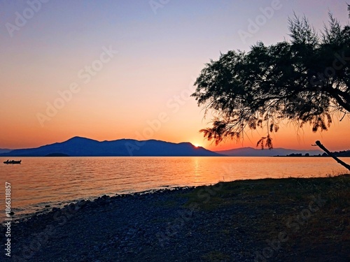 Greece - view of sunrise from the coast near the town of Kamena Vourla