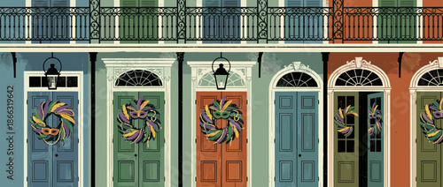 Row of colorful historic townhouses with ornate iron balconies and doors decorated for a festive carnival celebration with wreaths, masks, and beads
