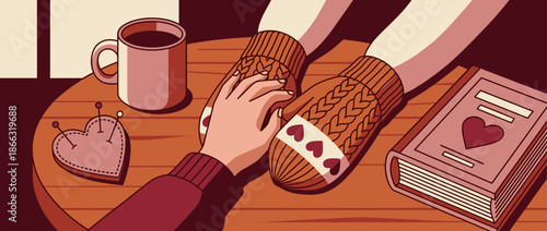 Person's hand gently touching a knitted mitten with hearts on a cozy wooden table with a book, coffee mug, and pincushion, illustrating a moment of love and comfort