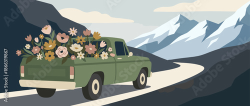 Green vintage pickup truck carrying flowers travels along a scenic road through a beautiful mountain landscape with snowy peaks under a cloudy sky