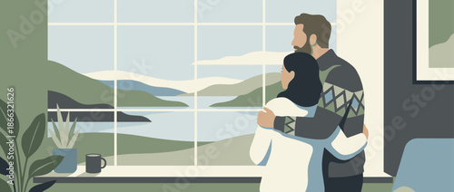 Young couple embracing warmly while looking out a large picture window at a serene mountain and lake landscape, enjoying a quiet moment together at home