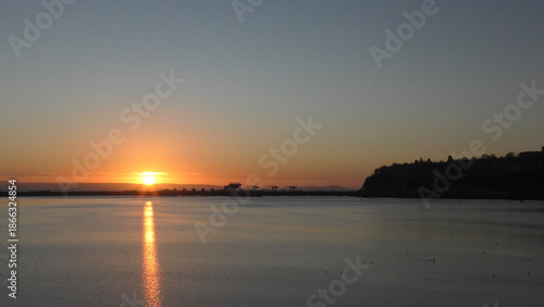 Calm Morning Sunrise over Cardiff Bay showing still water and the Barrage