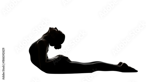 Silhouette of a woman in a yoga pose against a black background image