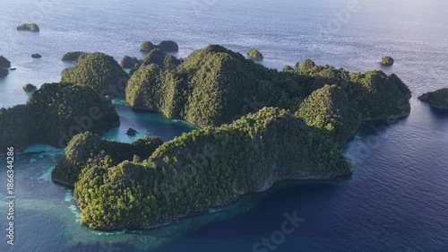 The scenic islands of Wyil rise from the seascape near Misool, Indonesia. This region harbors spectacular marine biological diversity and is a popular destination for divers and snorkelers.