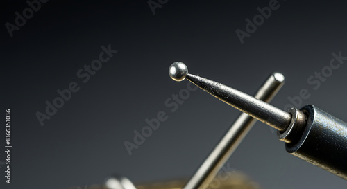 Close up of a metal probe tip touching another metal rod