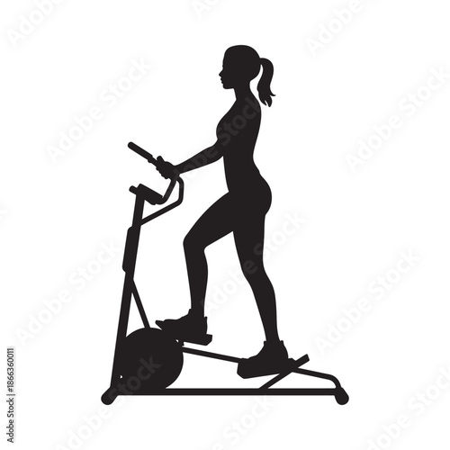 Silhouette of a woman exercising on an elliptical machine in a gym