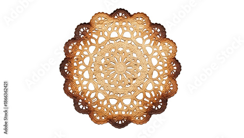 Ornate golden brown lace doily with intricate floral pattern on black background image