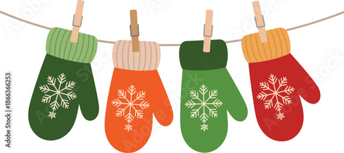 Colorful winter mittens hanging on a clothesline with snowflakes