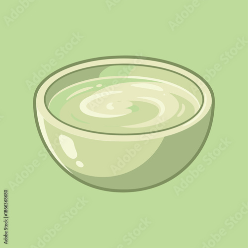 A bowl of creamy green soup with swirls.