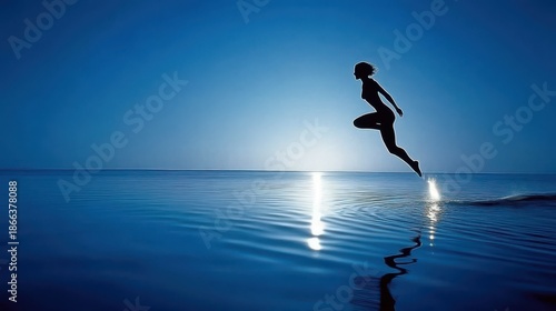 Silhouette of a Person Jumping Over Water with Calm Blue Tones and Reflections in a Serene Atmosphere at Dusk
