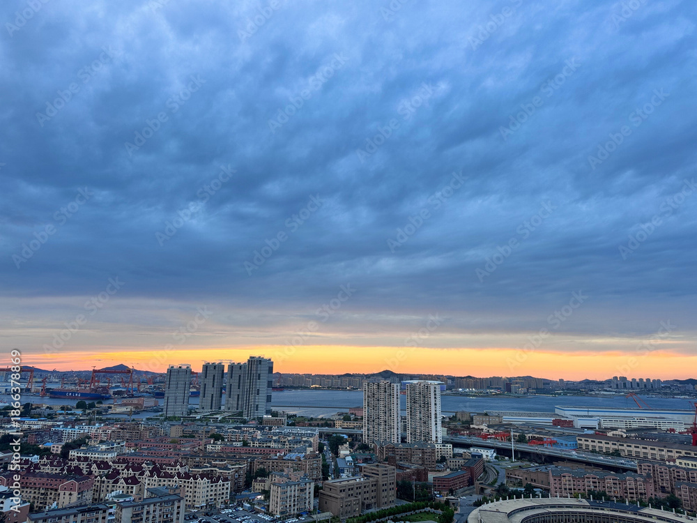 Fototapeta premium San Diego Skyline at Sunset with Cloud-Covered Sky and Bay View