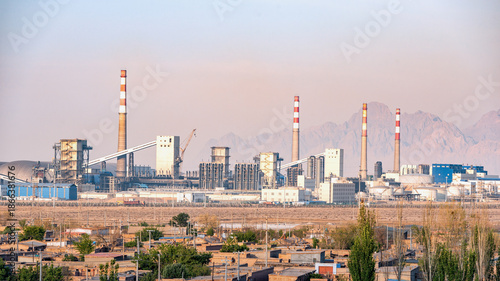 Photos Industrial Factory Plant with Smokestacks and Desert Landscape