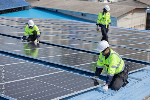 Engineer checking on solar panel on the factory rooftop