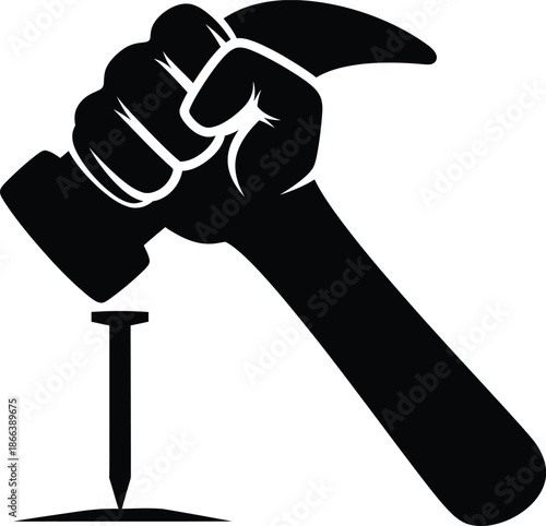 Powerful fist holding hammer driving nail into surface construction concept