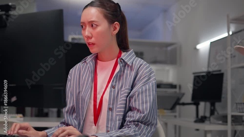 Cyber attack crisis shocked Asian woman in office workplace. Female looking at computer monitor after security breach, hacked system error, cyber security failure, cyber attack crisis.
