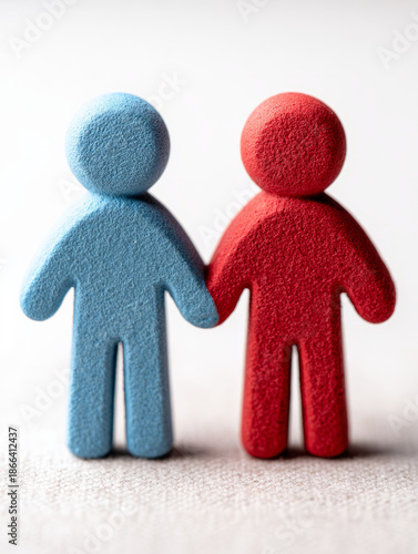 Two foam figures holding hands, symbolizing unity.