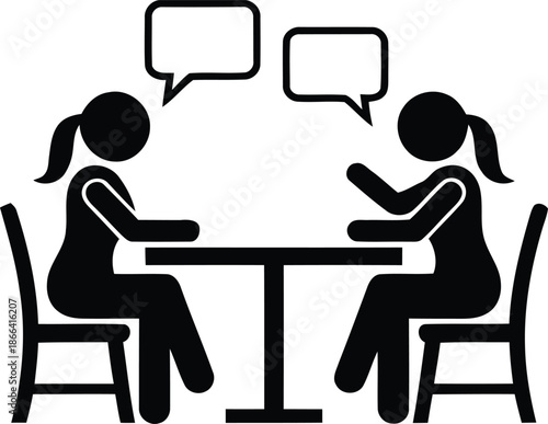 Two women having conversation at table