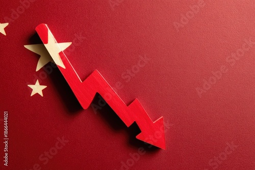 Wooden red arrow points down on a red surface with yellow stars, mimicking a flag