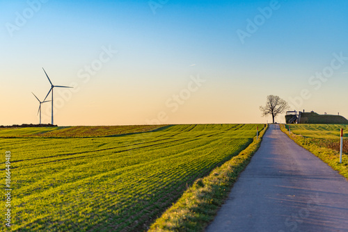 Country Road Through Green Fields With Wind Turbine Near Bourscheid, Luxembourg