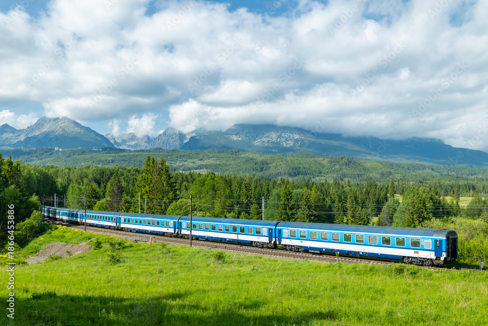 Fototapeta premium Passenger train winding through High Tatras mountains